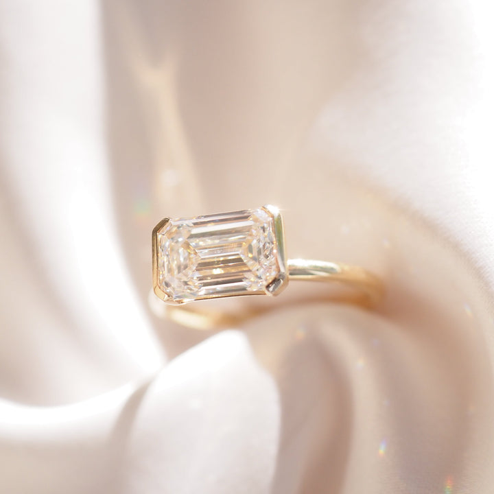 Evie | 2.5ct East West Emerald Half Bezel Solitaire Ring