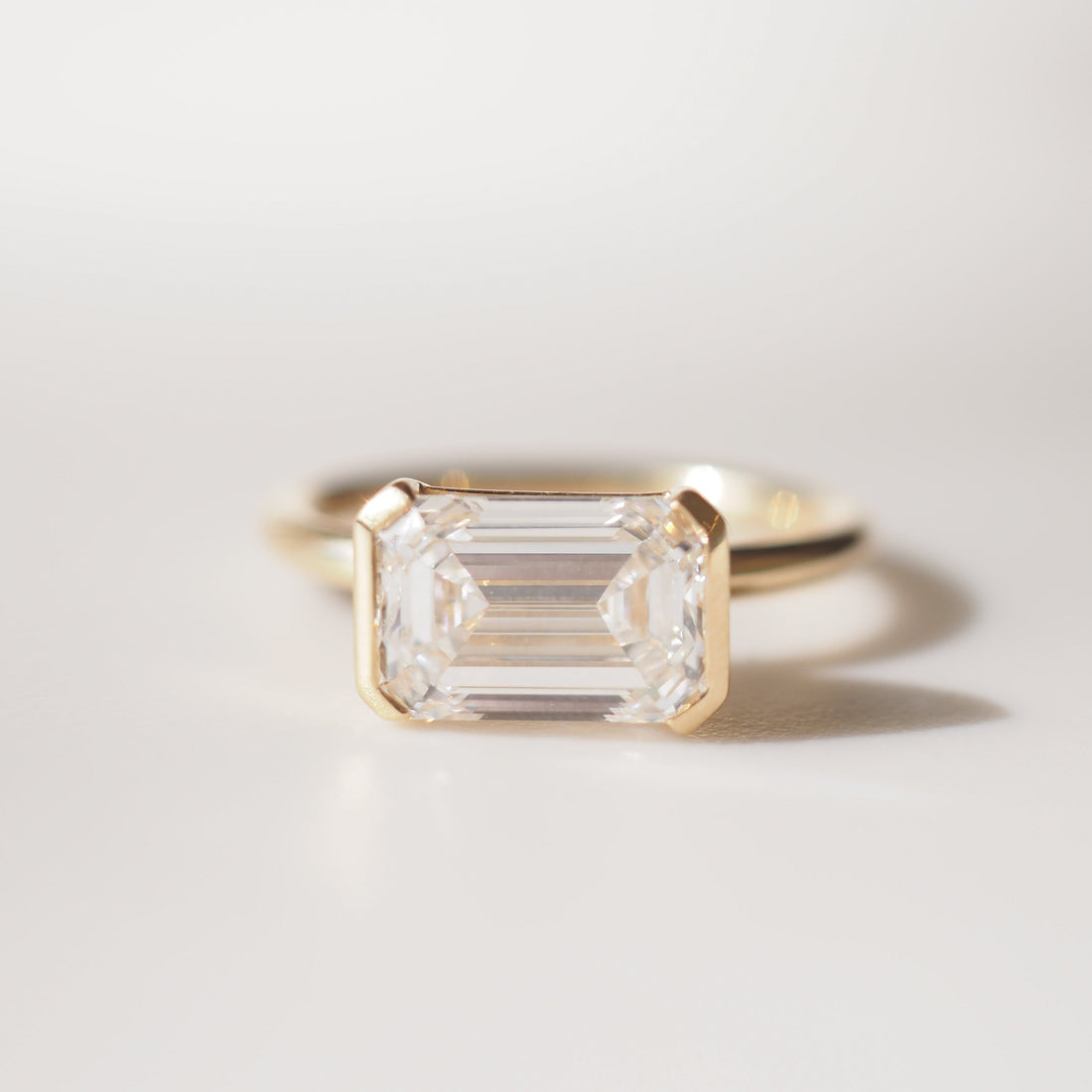 Evie | 2.5ct East West Emerald Half Bezel Solitaire Ring