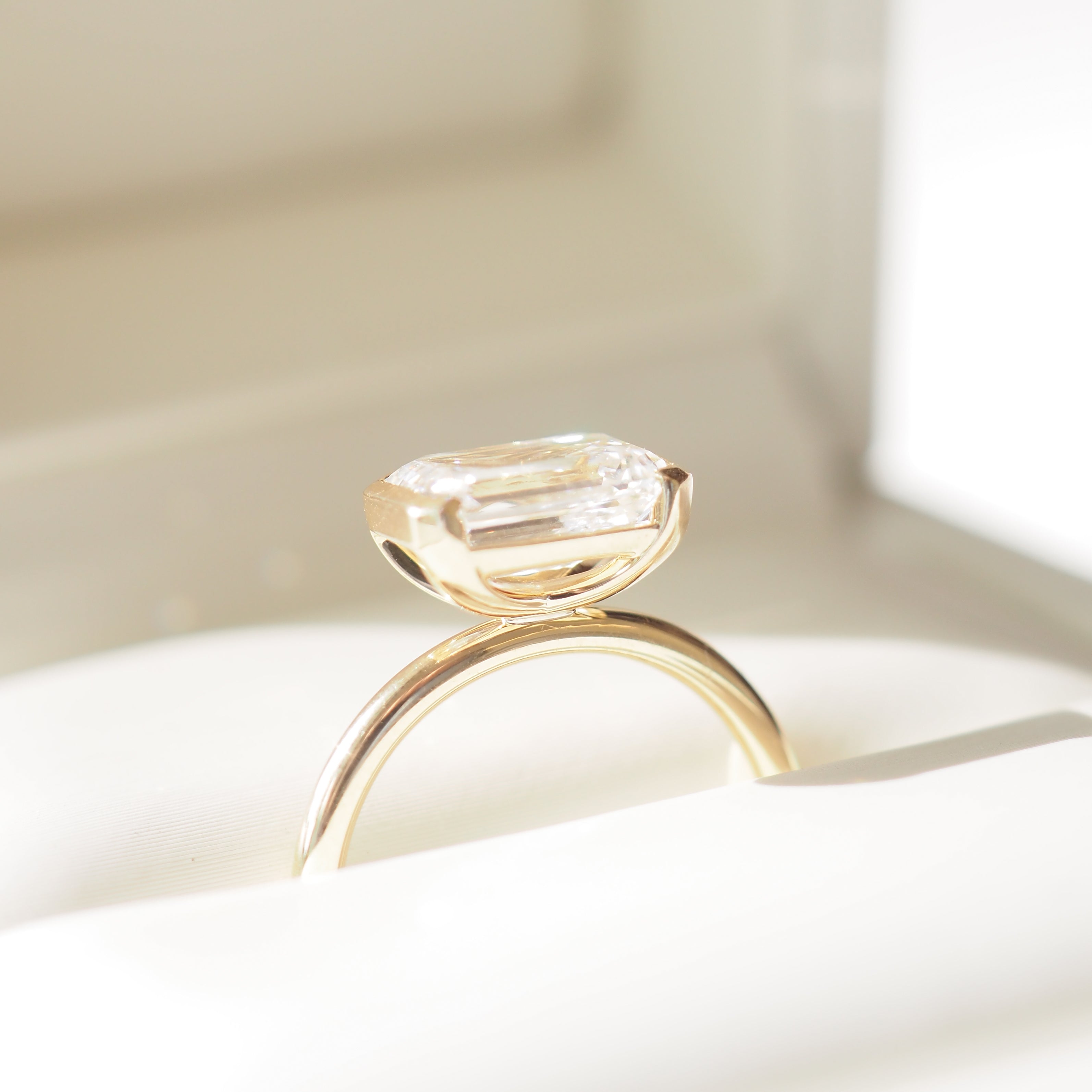 Evie | 2.5ct East West Emerald Half Bezel Solitaire Ring