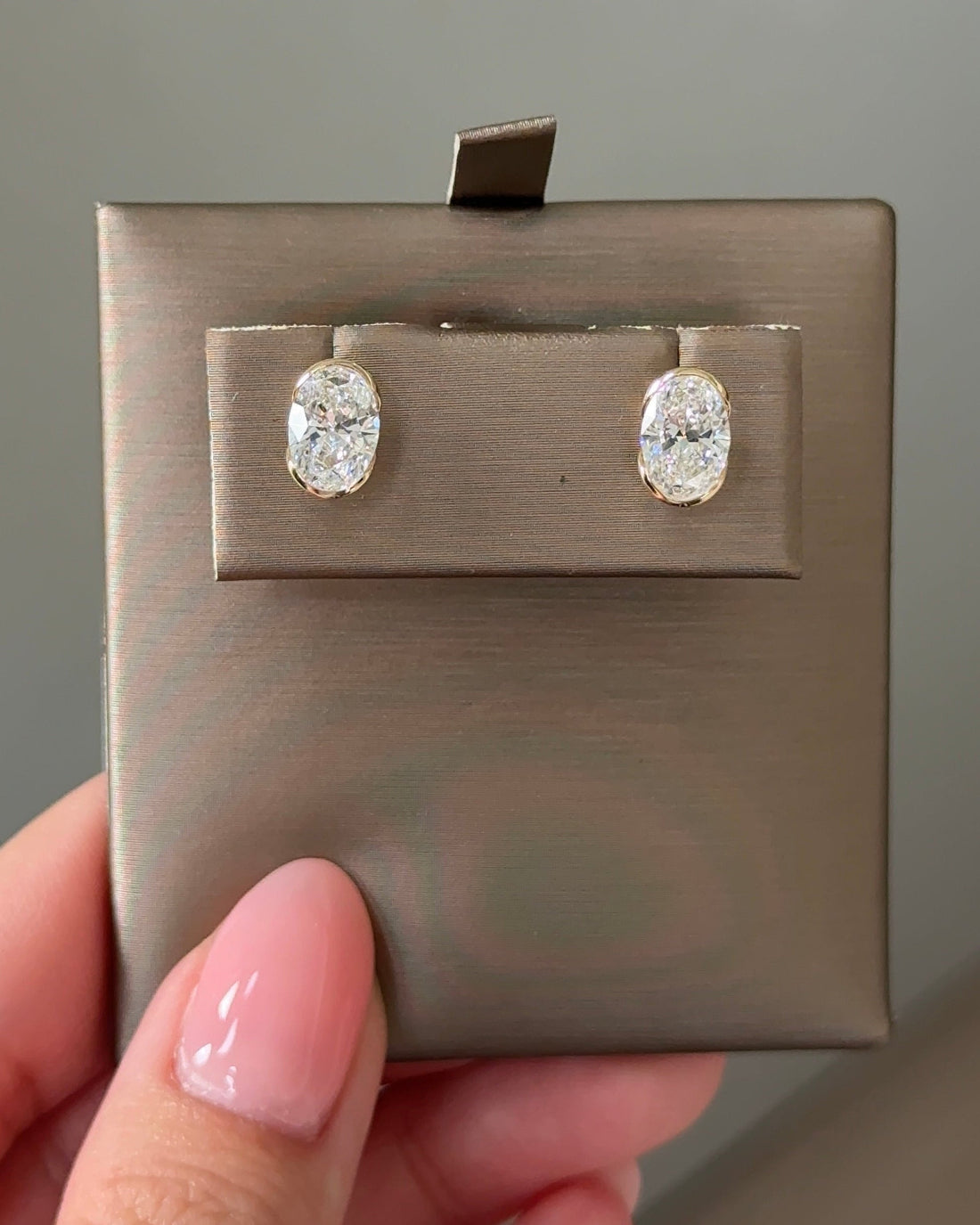 1 Carat Oval Diamond Stud Earrings in Bezel Arc Setting (with Comfort Fit Backing)