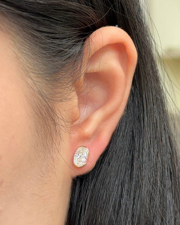1 Carat Oval Diamond Stud Earrings in Bezel Arc Setting (with Comfort Fit Backing)