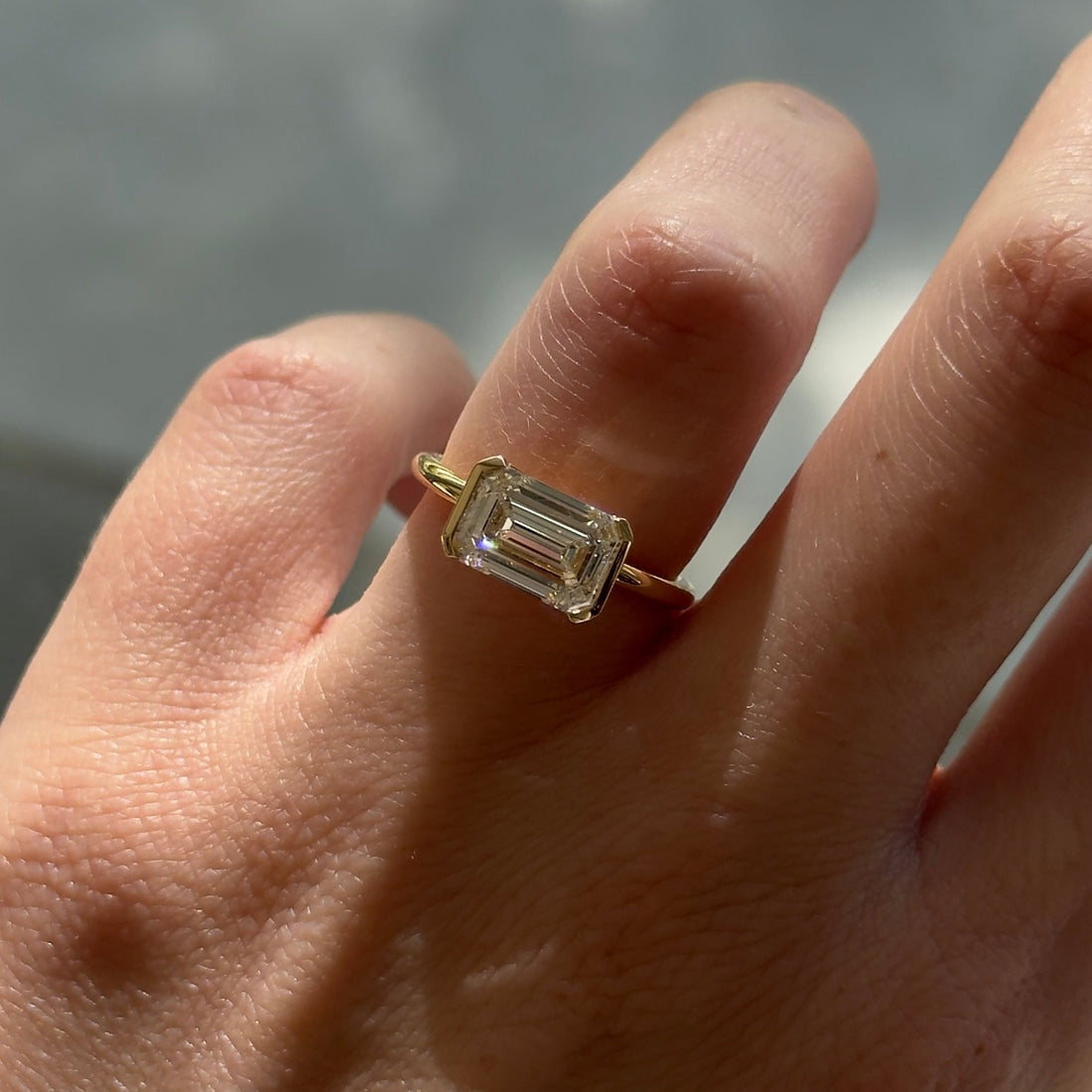 Evie | 2.5ct East West Emerald Half Bezel Solitaire Ring